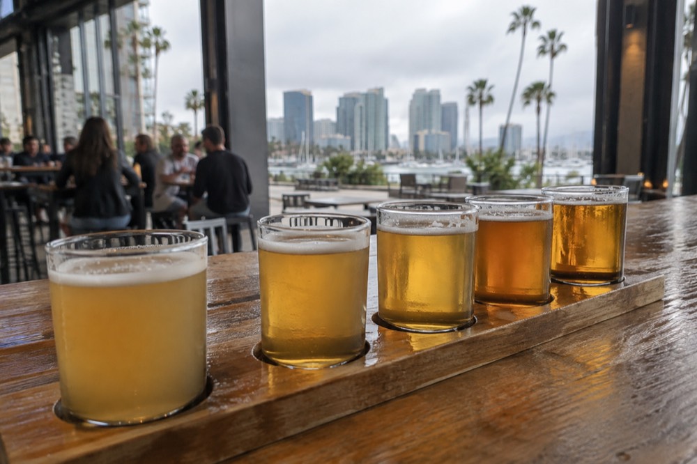 A flight of pale beers lined up on a brewery bar top