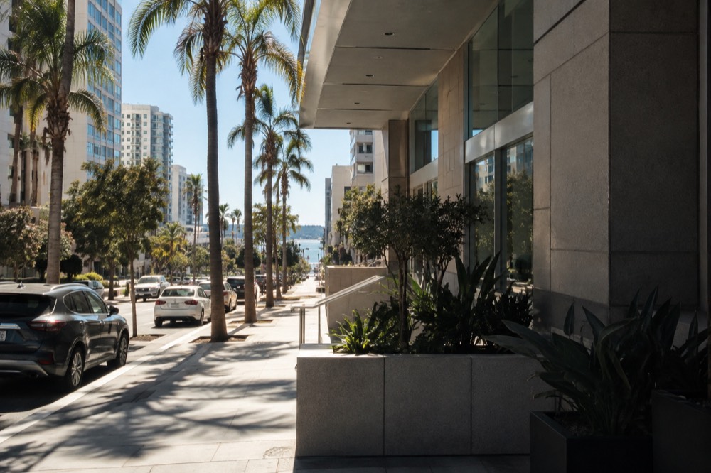 A quiet medical office building beside a palm-lined street in San Diego
