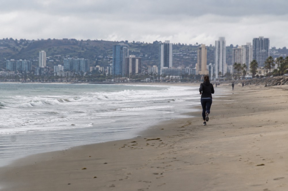 Empty San Diego beach with gray sky and gentle waves in winter