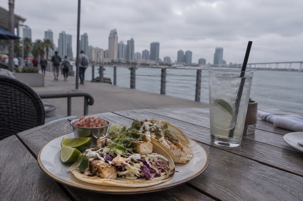A plate of fish tacos on an outdoor restaurant table in San Diego