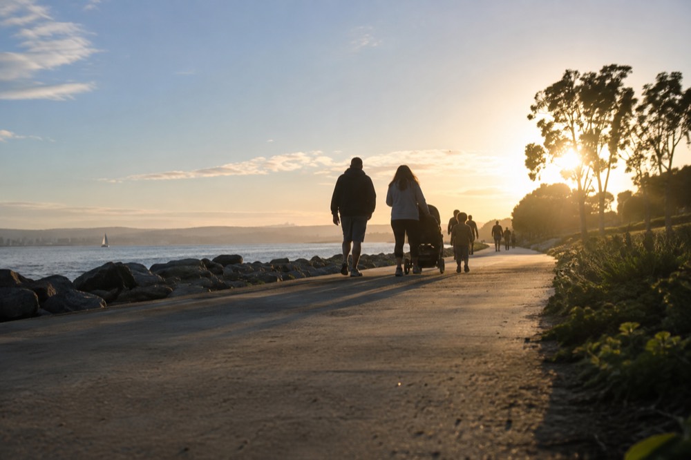 Families walking a waterfront path in Chula Vista with the bay on one side