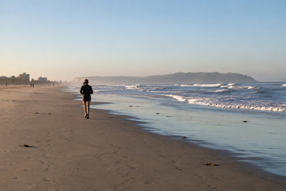Wide empty stretch of Coronado Beach with gentle waves and soft sand