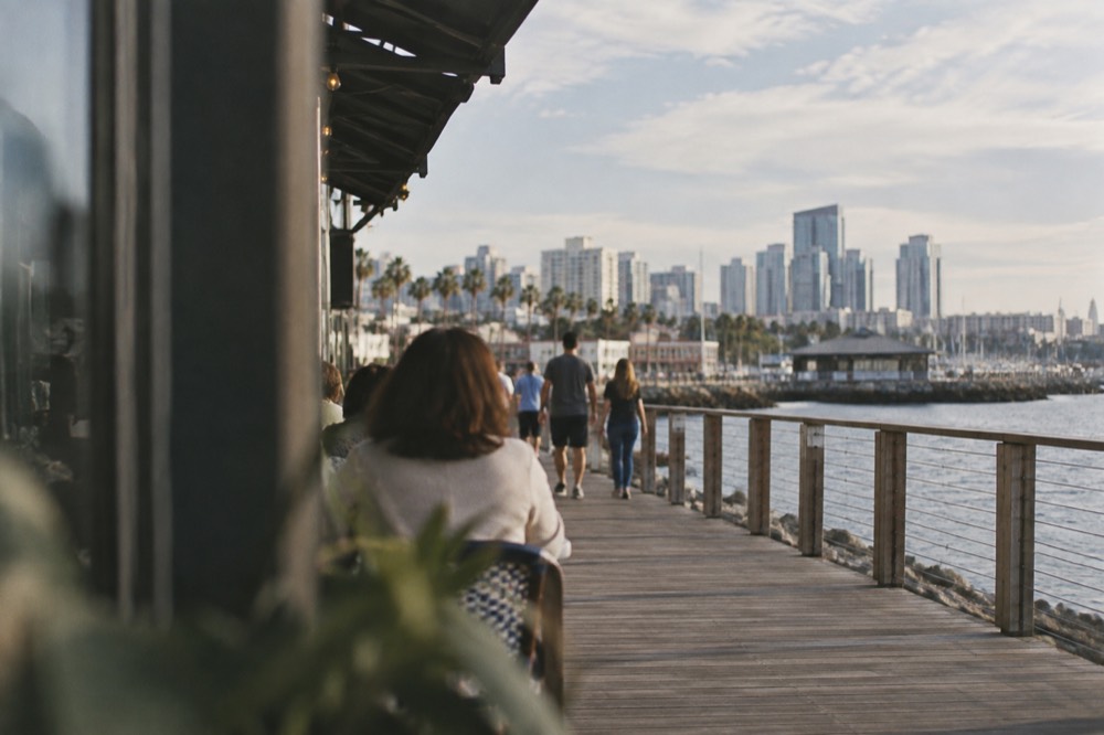 Waterfront boardwalk with shops and bay views at a bayside village complex