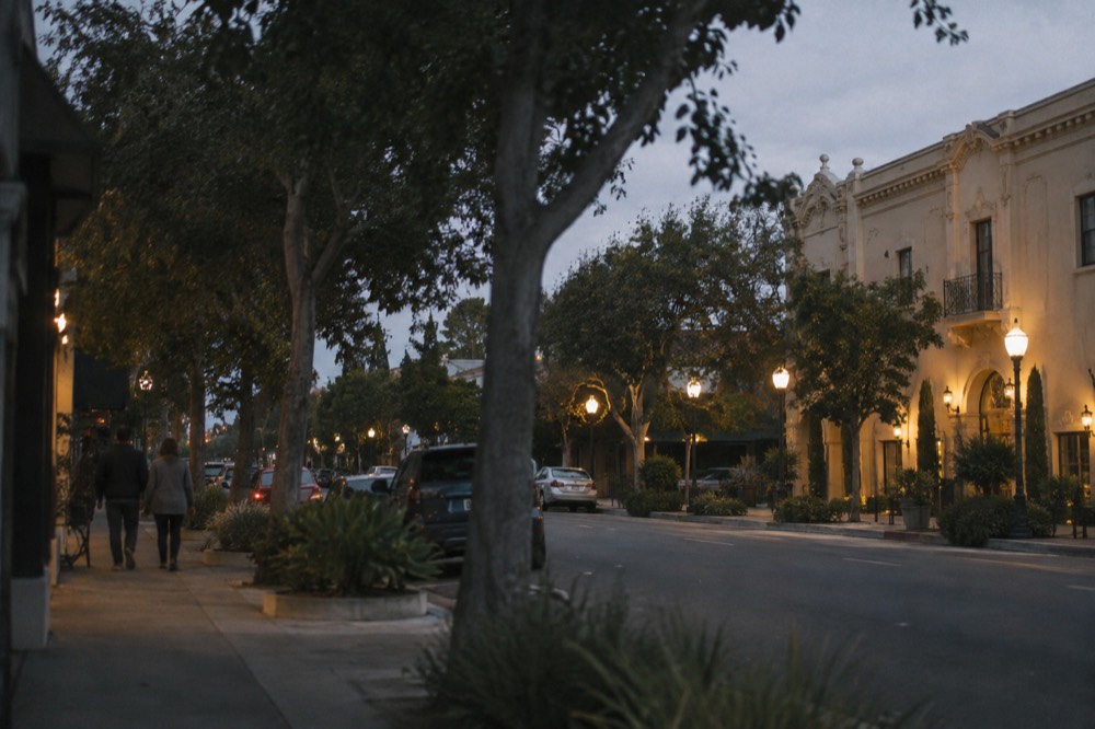 A historic building facade lit by streetlamps at night