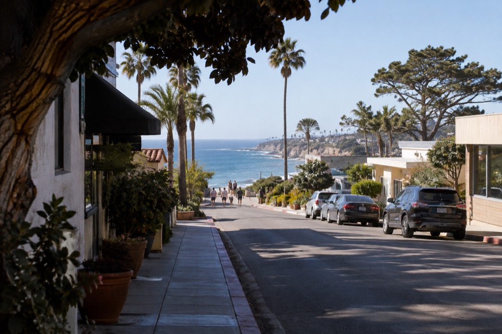 Quiet village street in La Jolla with palm trees and small shops in morning light