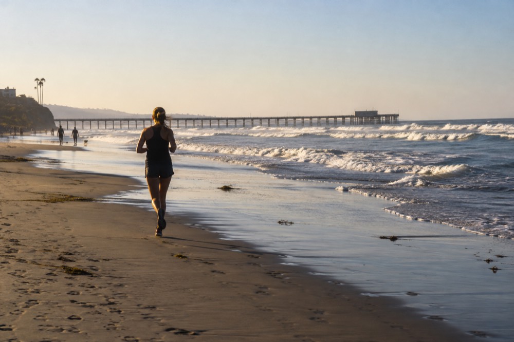 Ocean Beach shoreline with the wooden pier in the distance and waves breaking on the sand