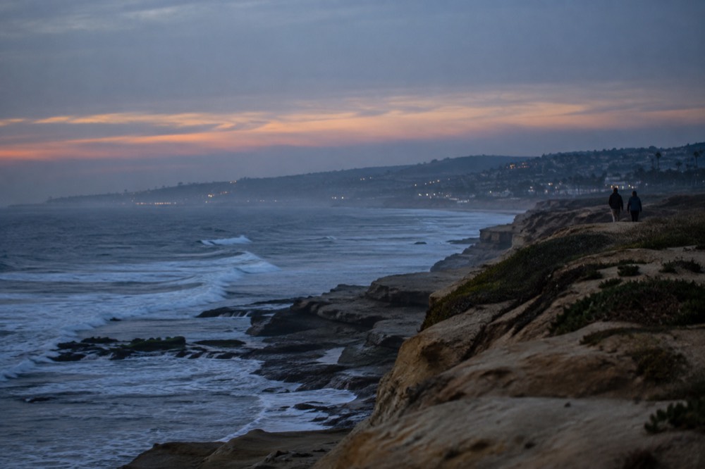 Sandstone cliffs along the coastline south of Ocean Beach with waves breaking below