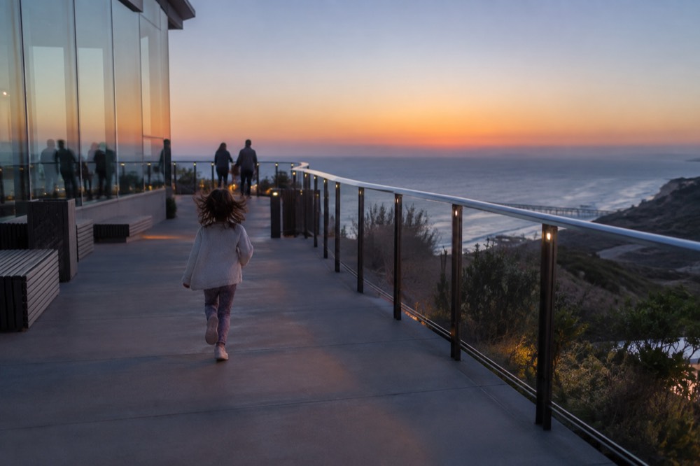 An aquarium terrace overlooking the Pacific Ocean at golden hour