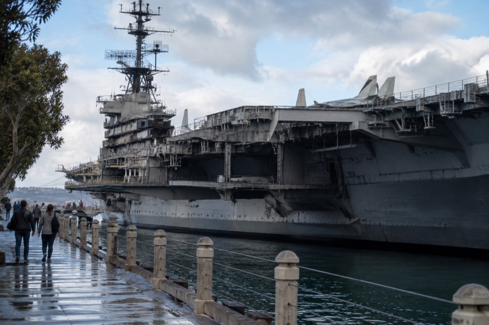 Historic aircraft carrier ship museum moored along a downtown waterfront