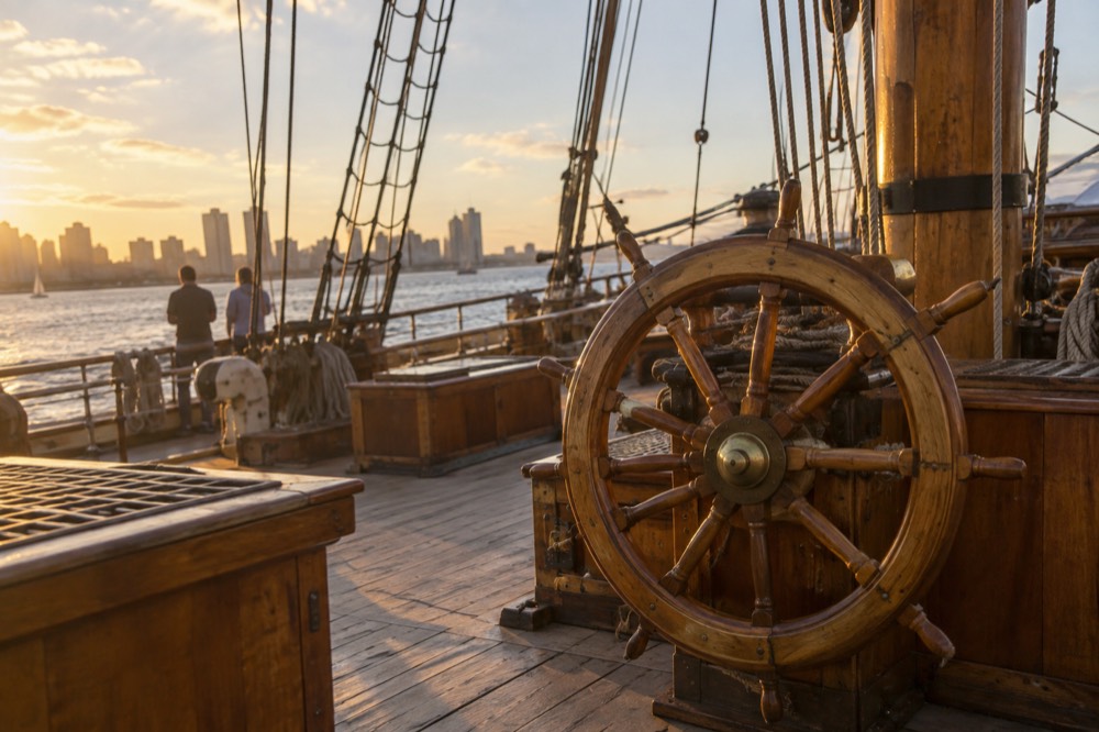 Wooden deck and ship wheel of a historic vessel at the maritime museum