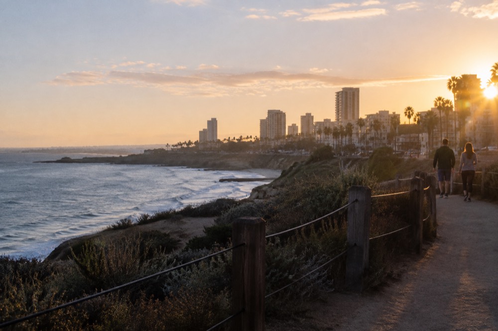 Coastal bluff path with ocean horizon in warm late-day light