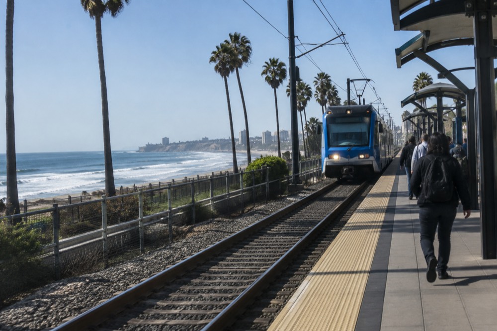 Blue Line trolley arriving at an outdoor station in San Diego on a clear day
