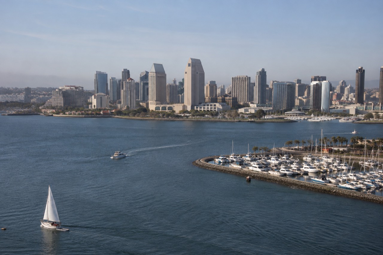 Aerial view of the San Diego waterfront with the bay and downtown skyline in afternoon light