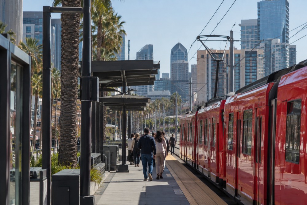 A red trolley car at a station platform in San Diego