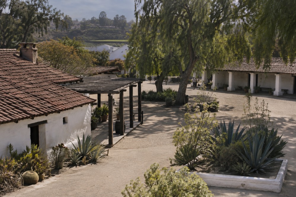 Historic adobe buildings and plaza in Old Town San Diego under afternoon light
