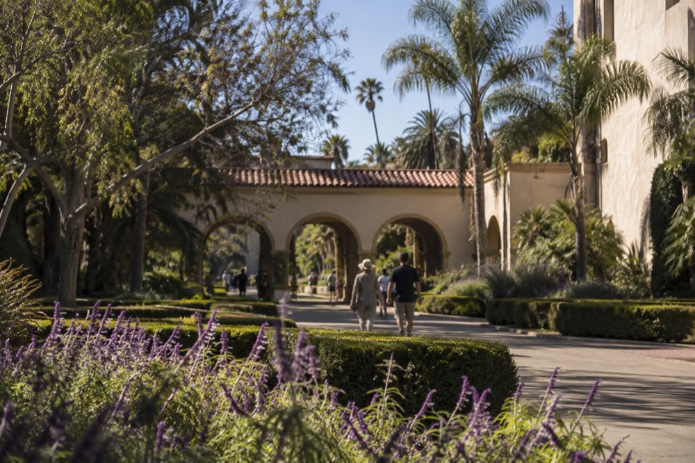 Gardens and Spanish colonial archways in Balboa Park on a sunny afternoon