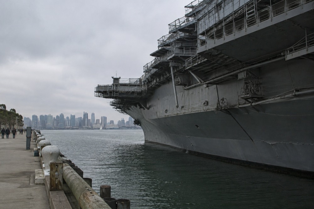 View over San Diego Bay with a Navy aircraft carrier moored at the downtown waterfront