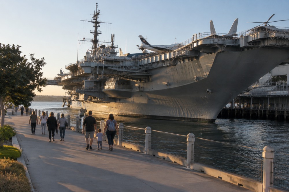 Families walking along the Embarcadero with the USS Midway aircraft carrier in the background