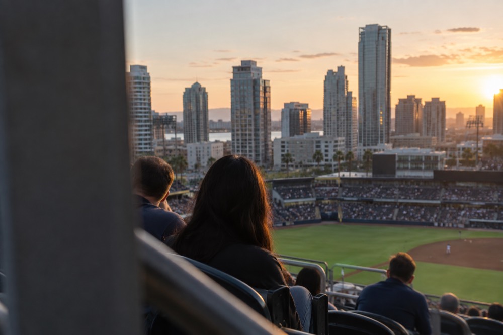 Stadium seats facing a downtown skyline with high-rise buildings at dusk