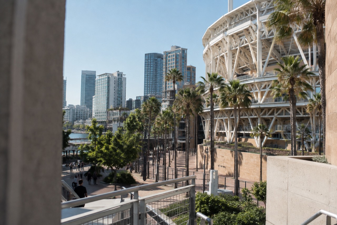 Baseball stadium exterior with palm trees and downtown San Diego skyline in the background