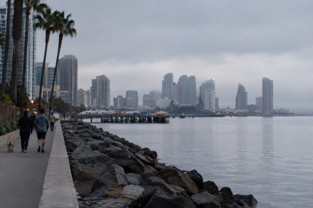 Low grey marine layer clouds resting over the San Diego coastline at dawn
