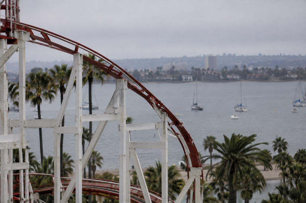 Roller coaster track curving against the Mission Bay skyline