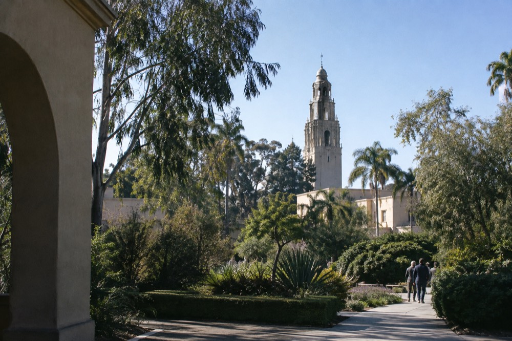 The California Tower at Balboa Park under a clear winter sky with gardens in the foreground