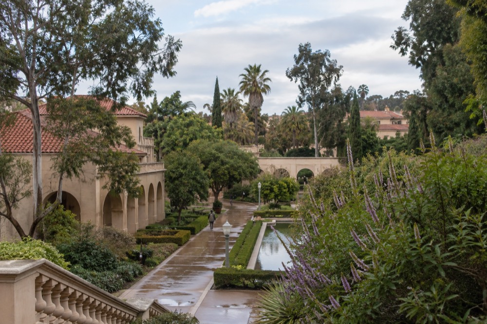 Balboa Park gardens and Spanish colonial architecture under soft light