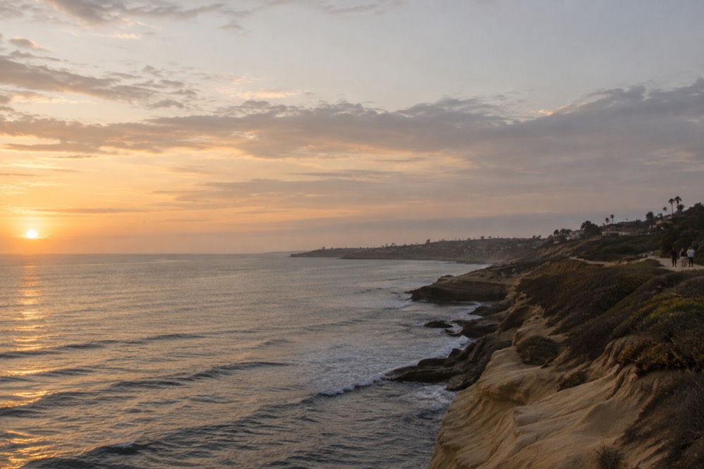 Golden late afternoon light over La Jolla coastline with calm ocean water
