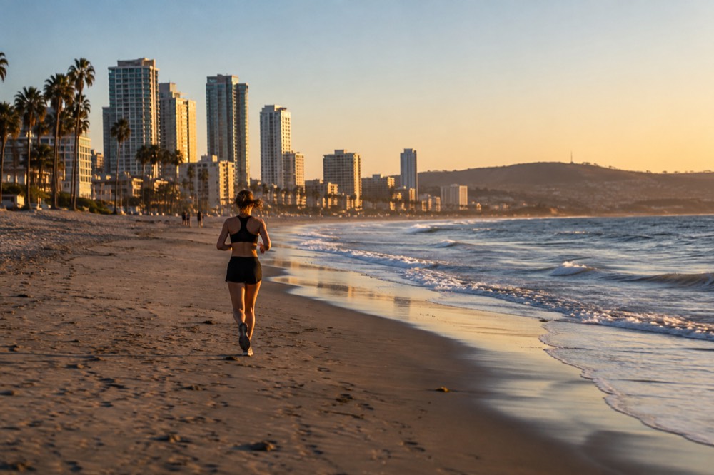 Empty sandy beach with gentle waves under a clear morning sky