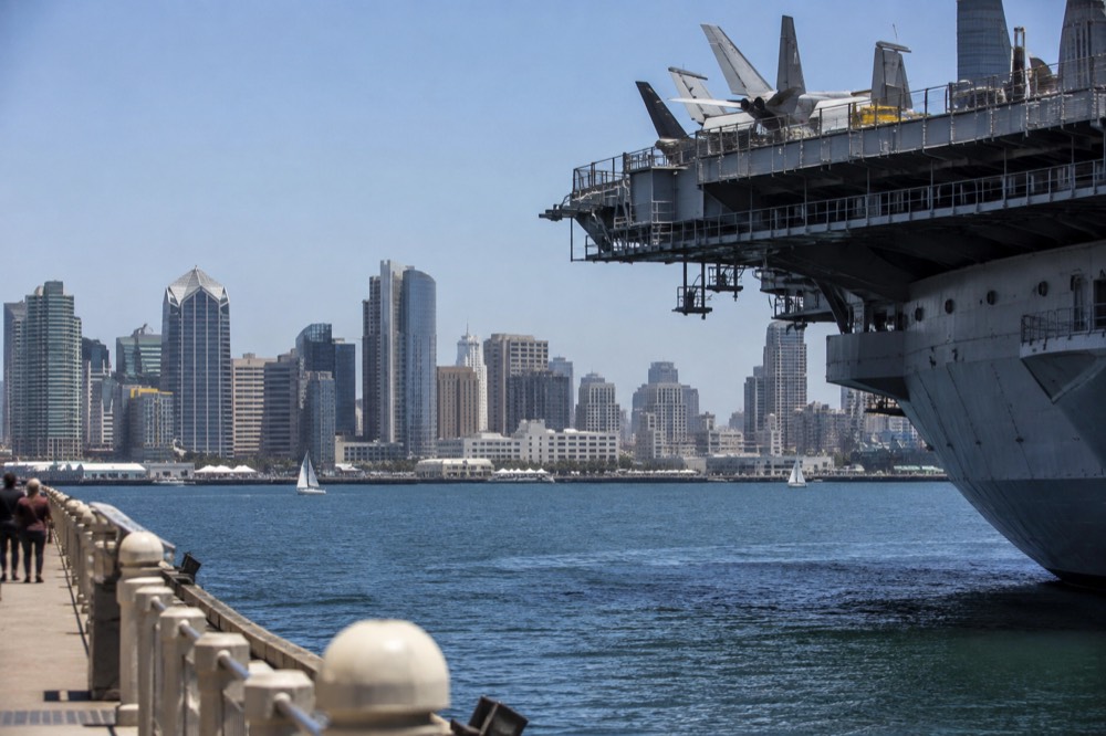 View over San Diego Bay with the city skyline and a historic aircraft carrier at the waterfront