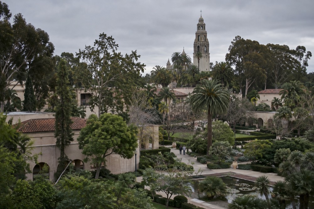 Panorama of Balboa Park gardens with the California Tower rising above trees