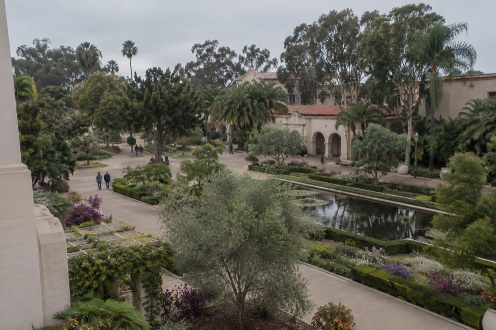 Balboa Park gardens and Spanish colonial style building facade in morning light