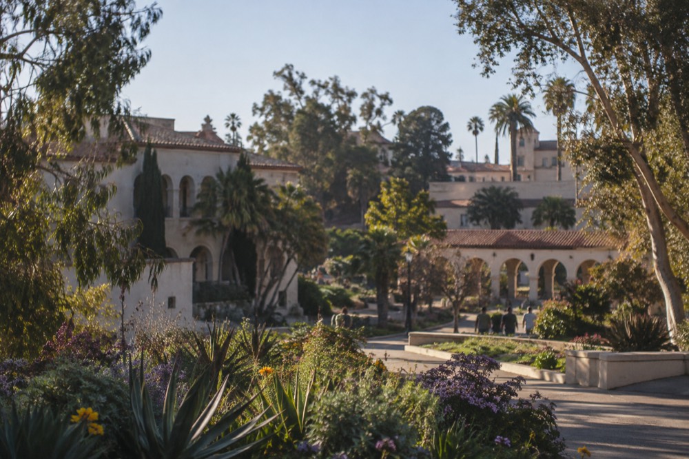 View over Balboa Park gardens and museum buildings under a clear sky