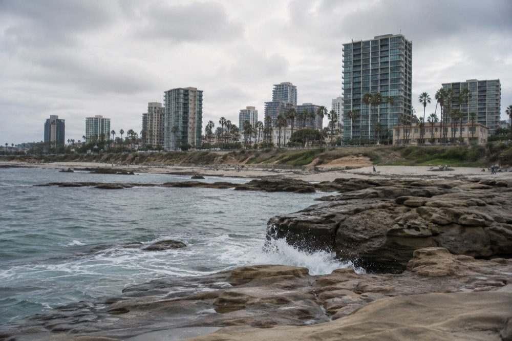 Turquoise cove water with sandstone cliffs and coastal rocks